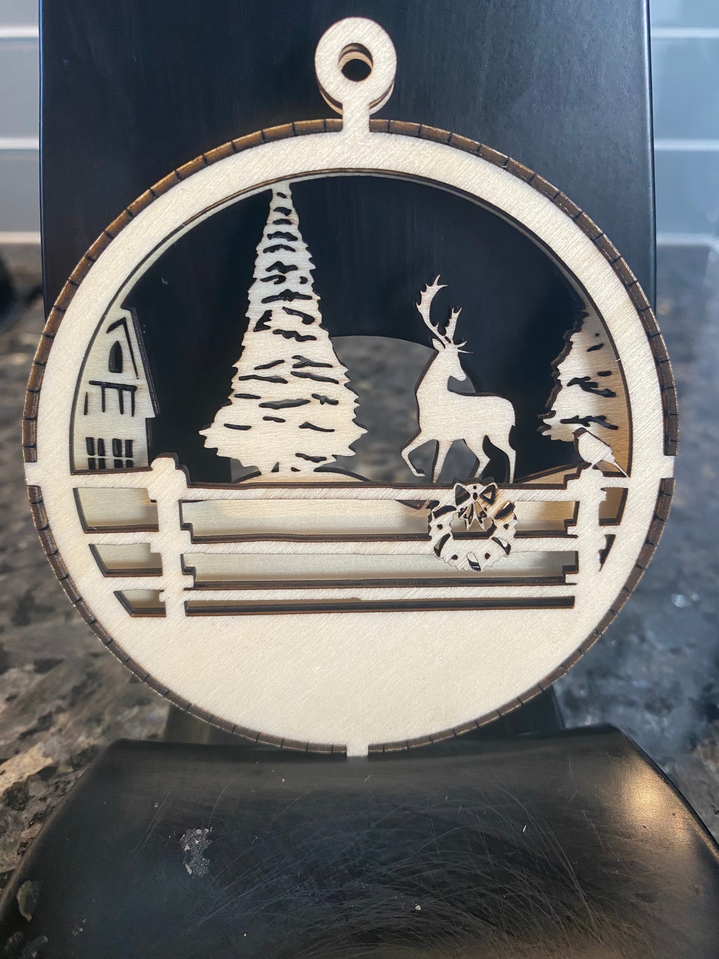 Wooden wintry forest scene ornament