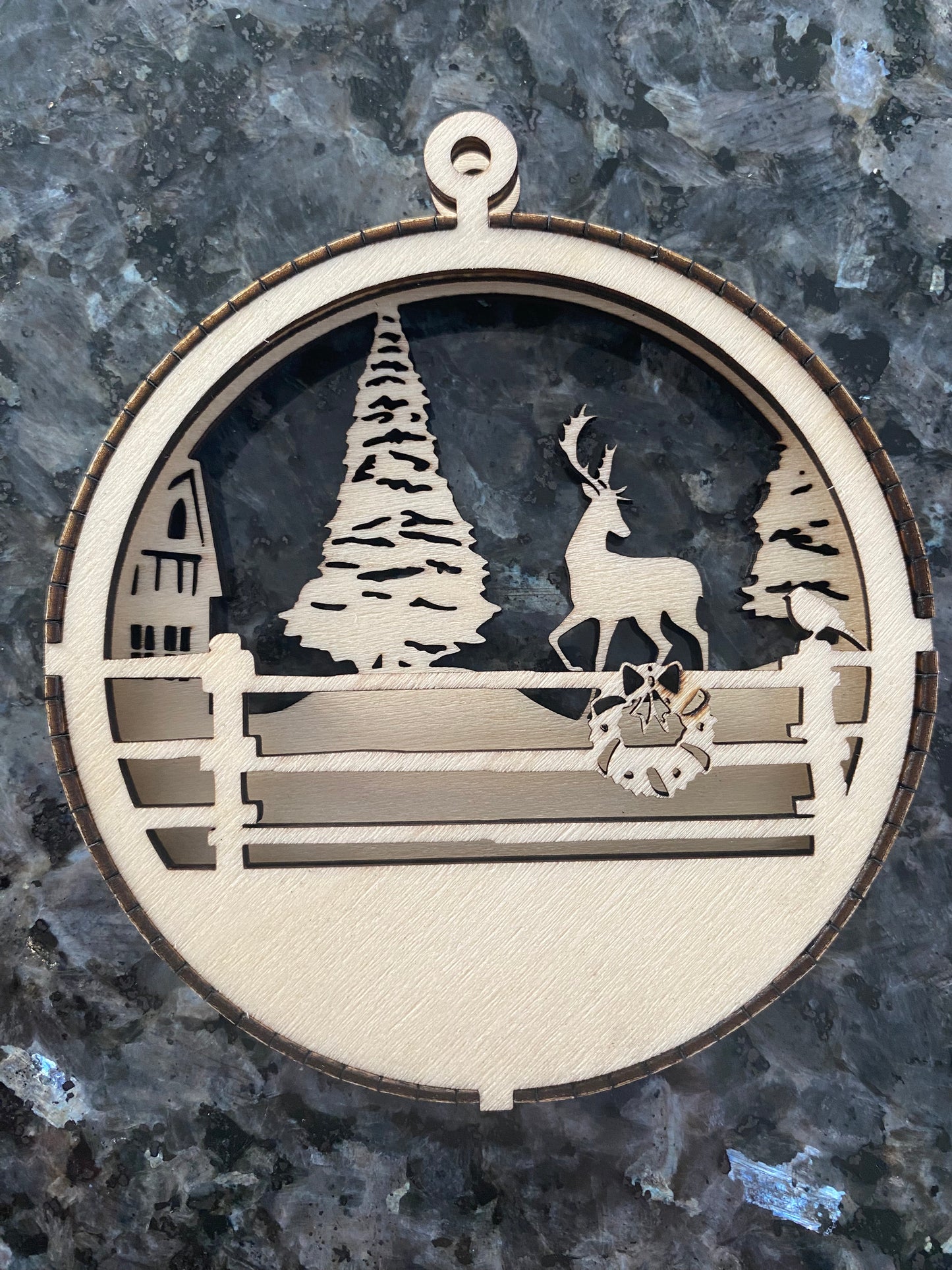 Wooden wintry forest scene ornament